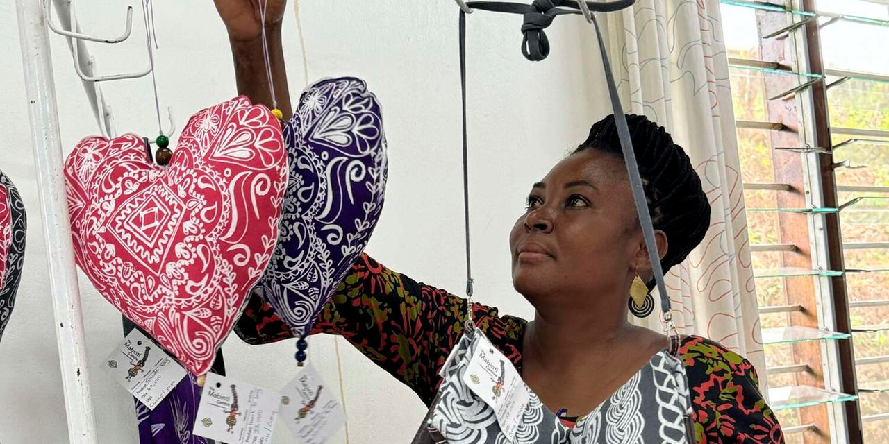 Lilian Mwela, a fistula survivor and a tailor at the CCBRT showcases some of the products they make at the Mabinti Centre in Dar es Salaam, Tanzania. 